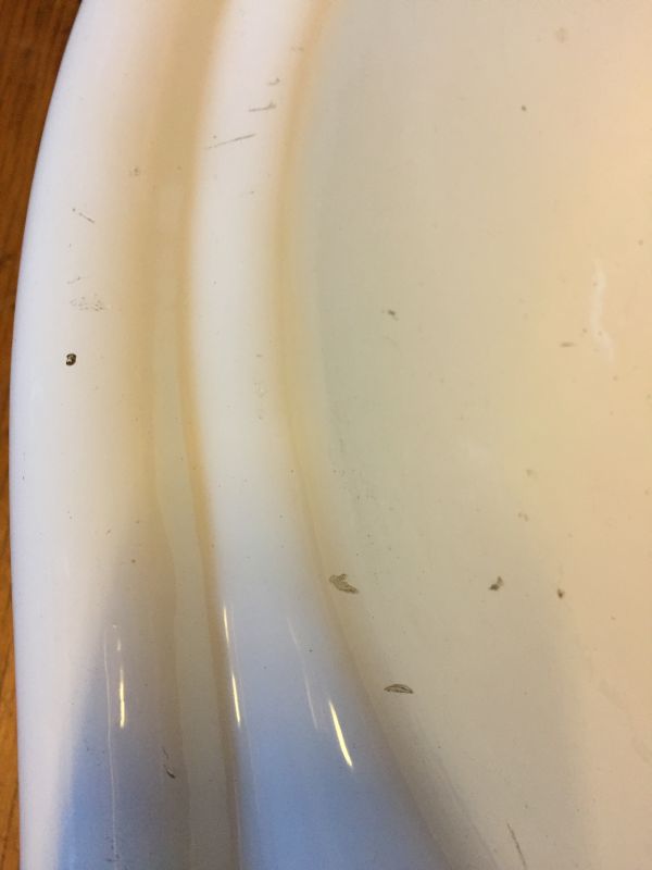 Photo shows damage on antique wall hung sink