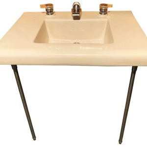 Front view of a Crane Criterion sink with legs and lever handles