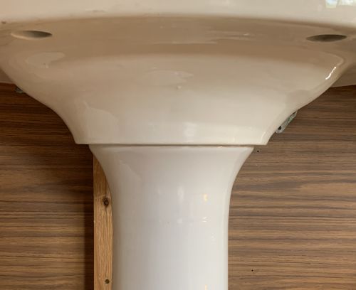 Ovatus sink pedestal, under view where ped connects to basin